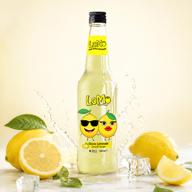 LoMo Classic Lemonade 330 ml bottle with fresh lemons, ice, and water splash.