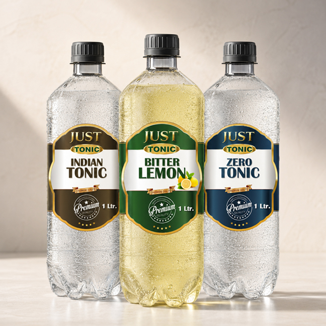 Three chilled 1-liter Just Tonic plastic bottles—Indian Tonic, Bitter Lemon, and Zero Tonic—displayed side by side with condensation on a light background.