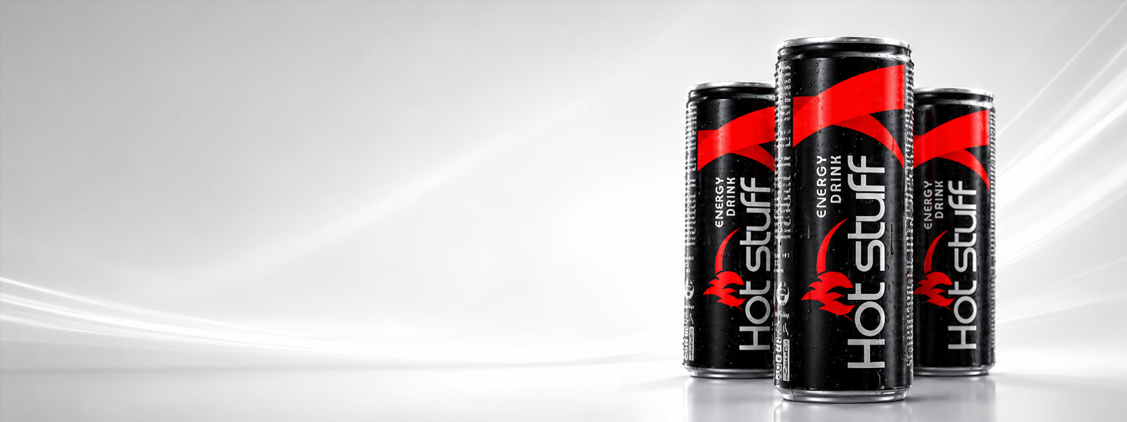 Hot Stuff Energy Drink black and red cans with water droplets on a bright white background.